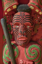Traditionally carved and painted figure of Maori