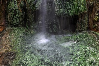 Small waterfall with green mineral deposits