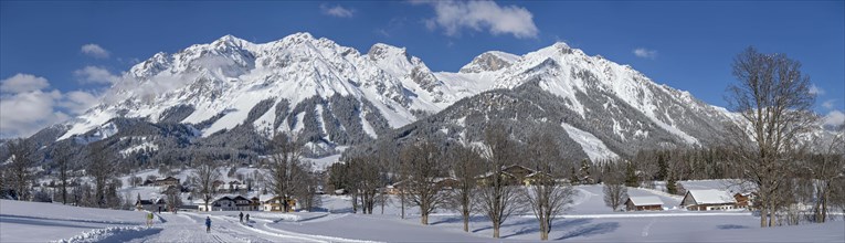 Cross-country skiing trail in front of the Dachstein massif in winter