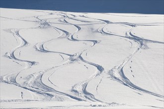 Ski tracks on a mountain slope in powder snow