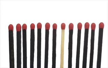 A bright match among several black matches