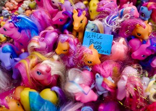 Plastic horses in a stall at a flea market