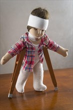 Doll with bandage on head