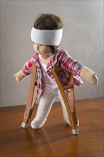 Doll with bandage on head
