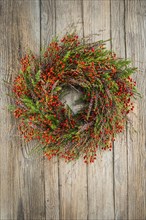 Autumn wreath on wooden wall