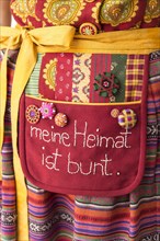 Six assorted Posamentenknopfe on work apron with yellow ribbons to Dirndl