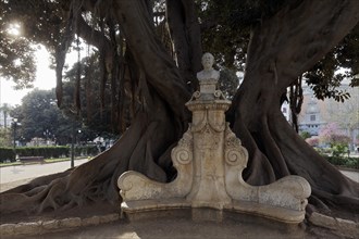 Monument of the painter Munoz Degrain under a huge tree