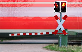 Train passes level crossing with barrier