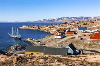 East Greenland town Ittoqqortoormiit with view to the harbour with sailboat