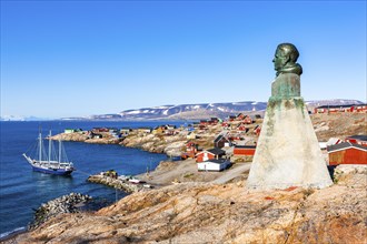 East Greenland town Ittoqqortoormiit with view to the harbour and the statue of Einar Mikkelsen