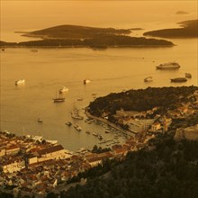 Town view Hvar with harbour and Pakleni islands at sunset