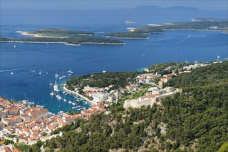 Overview of old town with harbour and fortress and Pakleni islands