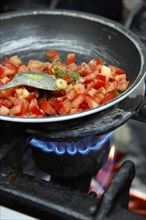 Diced tomatoes stewing in a pan