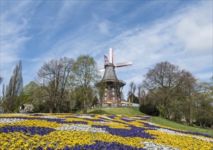 Colorful flowerbeds with windmill and ramparts