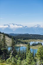 Small lakes in front of snow-capped mountains