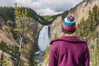 Young woman looking at a waterfall