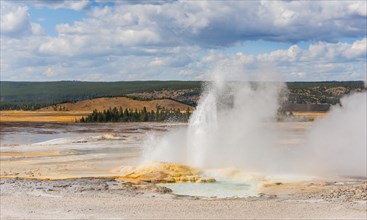 Steaming geyser with water fountain