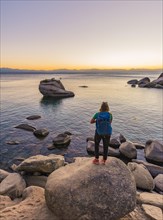 Young woman standing on the shore of Lake Tahoe