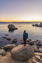 Young woman standing on the shore of Lake Tahoe