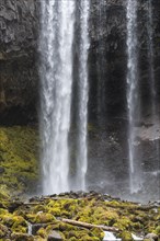 Waterfall plunges over rocky outcrop