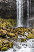 Waterfall plunges over rocky outcrop