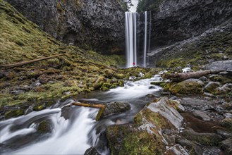 Hiker in front of a high waterfall