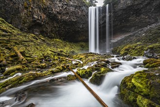 Waterfall plunges over rocky outcrop