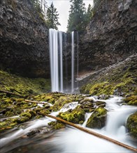 Waterfall flows over rocky outcrop