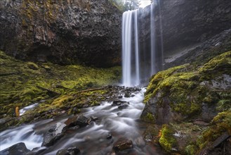 Waterfall plunges over rocky outcrop