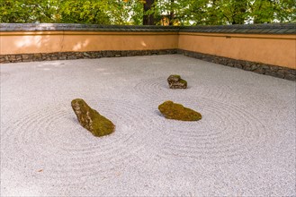 Japanese garden with gravel surface as symbol for water