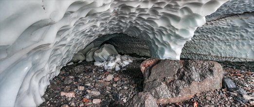 Entrance of an ice cave of a glacier