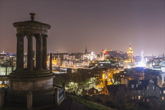 View from Calton Hill with the Dugald Stewart Monument over the historic Old Town with Edinburgh Castle at night