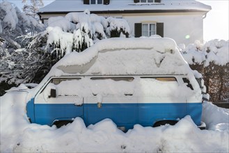 Snow-covered parking car in the residential area
