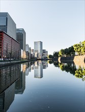 High-rise buildings reflected in a canal