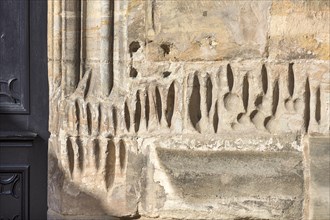 Medieval sharpening grooves on a church wall
