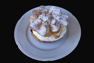 Cream puff on a white plate