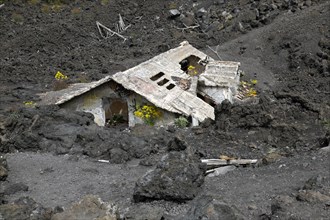House covered with lava on the slopes of Mount Etna