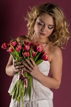 Young woman posing with bouquet of flowers