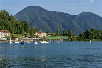Tegernsee with sailboats and boat cabins