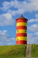 Pilsum lighthouse with blue cloudy sky