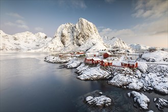Town and fisherman's cabins or Rorbus in front of snowy mountains