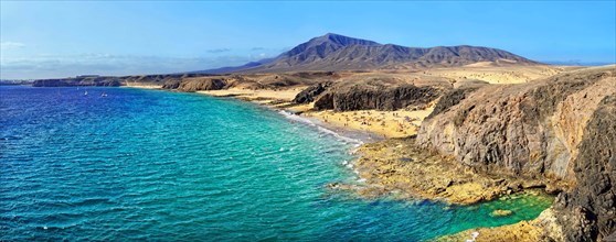 Sandy beach and rocky coastline with turquoise waters of Playa del Papagayo