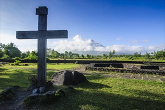 Christian cross before volcano Mayon
