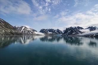 Mountains reflecting in the water in the Magdalenefjorden