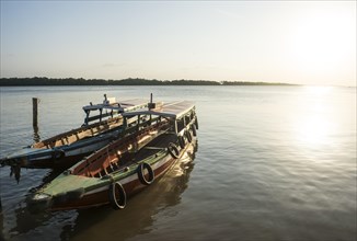 Boats at sunset on the Suriname river near Paramaribo
