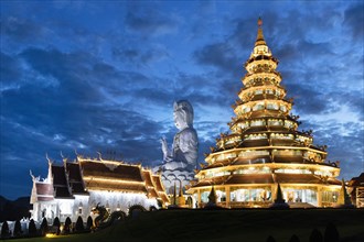 Nine-storey Chinese pagoda and chapel with huge Guan Yin statue at dusk