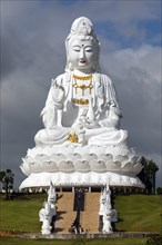Giant Guan Yin statue sitting on lotus flower