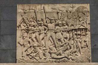 War scene on a memorial plaque at the Memorial Monument