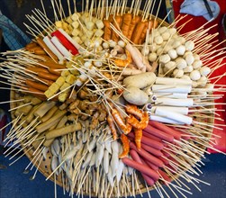 Various skewers with sausage and meat