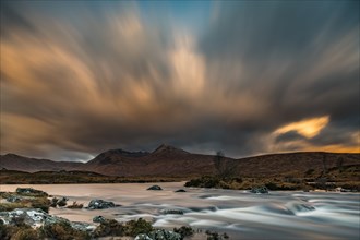 River Ba with mountain peaks of Meall aÂ´Bhuiridh and Clach Leathad in the background and dramatic clouds